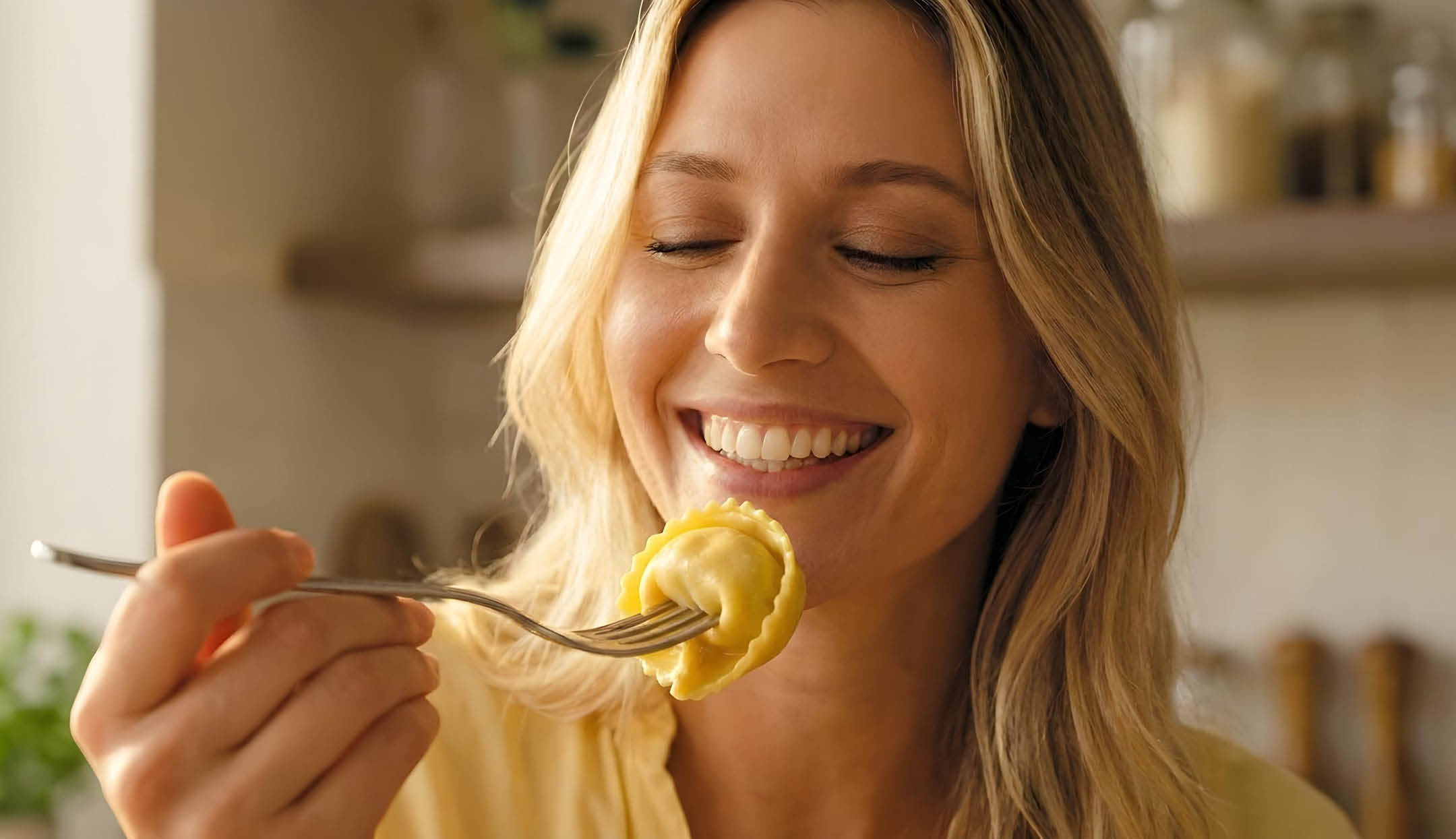 Primo piano di donna che mangia un tortellino